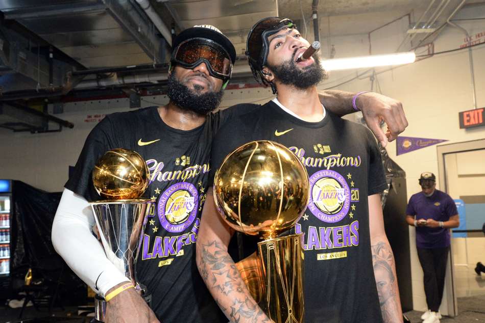 A powerful shot of LeBron James and Anthony Davis celebrating with the NBA Championship trophy in the Orlando bubble.